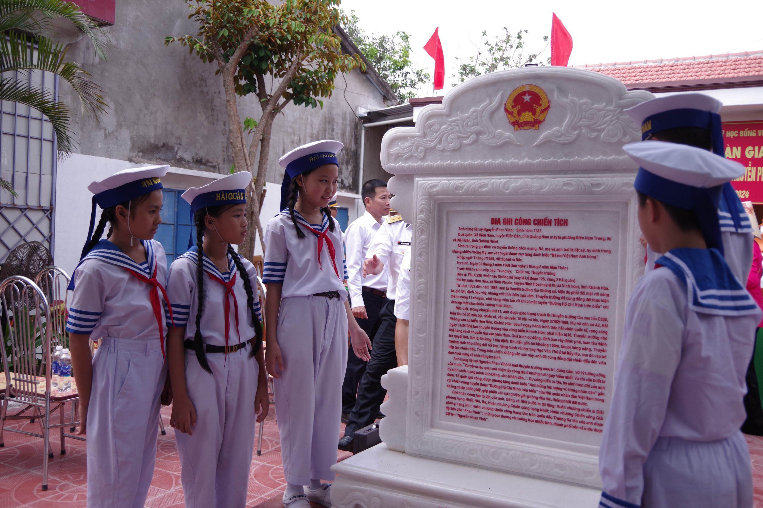 Các em học sinh Trường tiểu học Nguyễn Phan Vinh bên cạnh bia ghi chiến công Anh hùng liệt sỹ