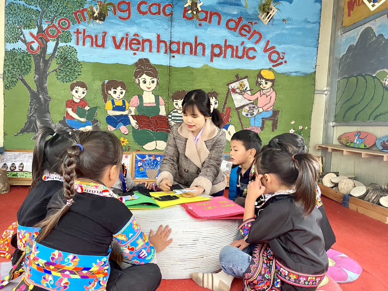 Giáo viên Trường Mầm non Sì Lở Lầu giáo dục cho các em học sinh về trang phục của các dân tộc.